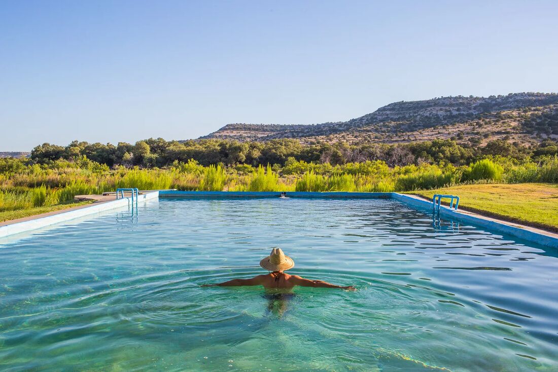 A hillside pool overlooking West Texas
