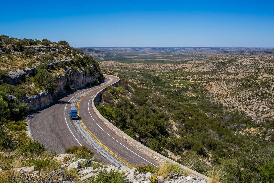 A ranch road winding through West Texas
