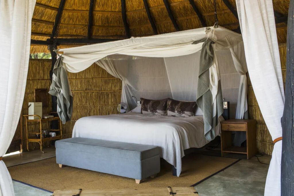 A canopy bed in a luxury safari tent