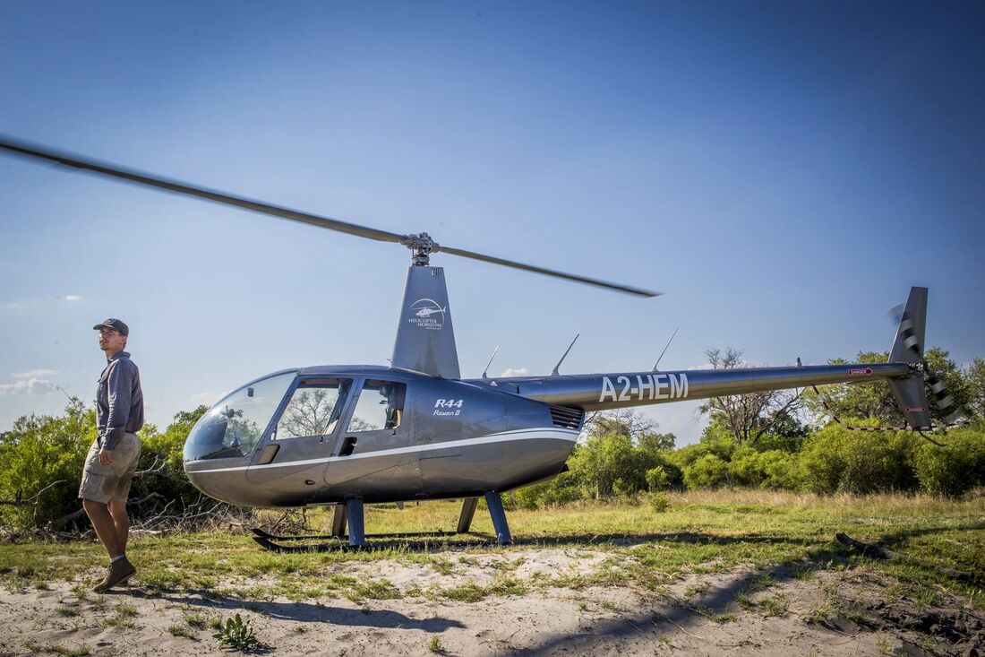 A helicopter on a sand airstrip in Botswana